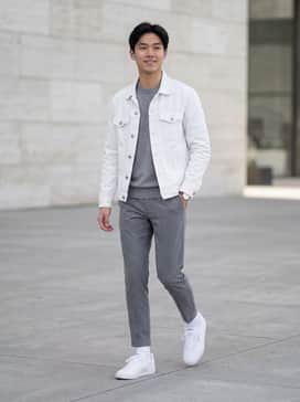 Slim-fit dark indigo denim, a crisp white crewneck tee, and an unbuttoned olive green flannel shirt for a classic layered look.