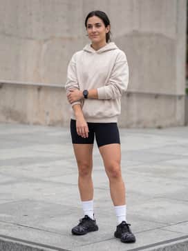 High-waisted black biker shorts topped with an oversized beige graphic hoodie and white crew socks to highlight the 3D-printed midsole.