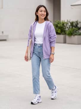 High-waisted light wash straight-leg jeans with a cropped white baby tee and a lavender oversized zip-up hoodie.