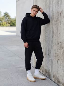 Style with black athletic joggers and a matching oversized hoodie for a clean, gym-to-street athleisure aesthetic.