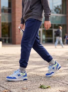 Navy blue joggers paired with a heather grey hoodie and a lime green beanie to pick up the shoe's vibrant accents.
