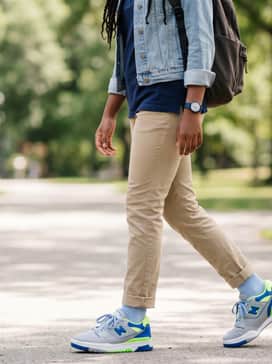 550 – Slim-fit khaki chinos with a navy blue polo shirt and a light denim jacket for a polished yet comfortable school outfit.