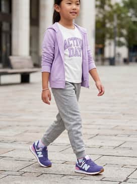 A sporty-casual look featuring heather grey joggers, a white graphic t-shirt with purple lettering, and a lightweight lavender zip-up hoodie for layering.