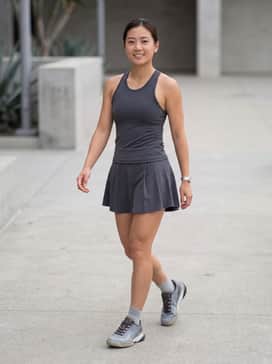 On-Court Sophistication: Pair these sneakers with a sleek, charcoal-colored pleated tennis skirt and a matching moisture-wicking racerback top for a professional athletic look.