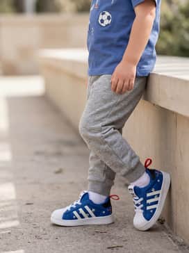 Adidas Disney Adifom Superstar 360 Shoes – Grey jersey joggers paired with a graphic tee featuring soccer or Disney motifs to complement the shoe's patterns.