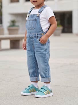 Adidas Disney Grand Court 30 Shoes Infants – Cuffed light-wash denim overalls worn over a white graphic tee to highlight the sneaker's vibrant teal base.