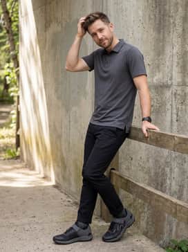 Adidas Five Ten Clipin Mountain Bike Shoes – Slim-fit black technical chinos and a fitted performance polo shirt, perfect for a rider transitioning from a morning trail session to a casual coffee meetup.