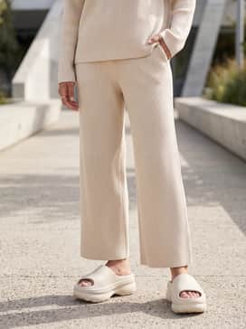 Adifom Stan Slides – A monochromatic ribbed knit lounge set featuring wide-leg trousers and a matching cropped tank top.