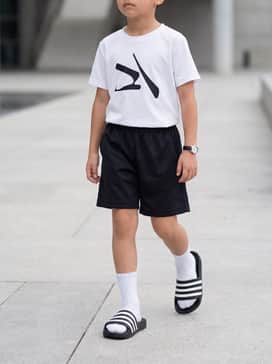 Pair with black mesh athletic shorts, a white moisture-wicking graphic t-shirt, and white crew socks for a classic sporty look.