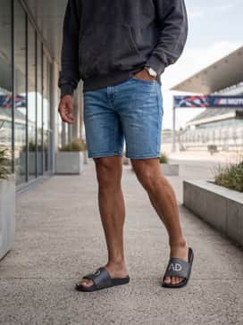 Light-wash denim shorts paired with a charcoal grey oversized hoodie for an effortless streetwear-inspired look.