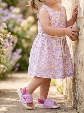 Floral print sun dress in shades of lavender and pink, perfect for a garden party or outdoor family picnic.