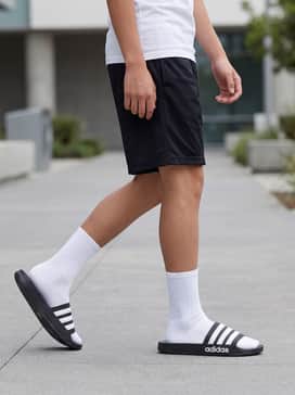 Pair with black mesh basketball shorts, a white compression t-shirt, and white crew socks for a classic athletic look.
