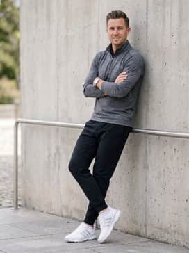 Black technical joggers and a quarter-zip athletic pullover in a heathered charcoal grey for a sporty range session.