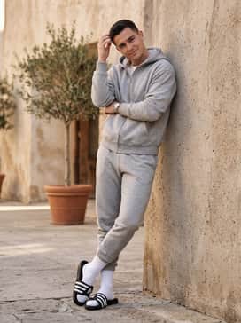 Adissage Slides – A comfortable loungewear set with tapered fleece joggers in heather grey, a matching zip-up hoodie, and high-quality ribbed cotton socks for maximum indoor comfort.