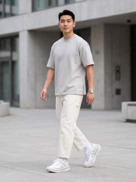Off-white wide-leg carpenter pants paired with a boxy light grey heavyweight t-shirt and a silver-toned watch for a clean, tonal aesthetic.