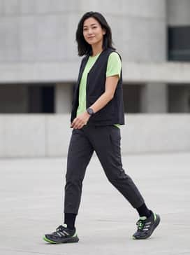Adizero Aruku Shoes – A sleek tech-wear outfit with black tapered cargo joggers, a lime green moisture-wicking tee, and a matte black utility vest.