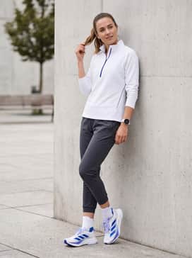 Adizero Boston 12 Shoes – Tapered charcoal grey joggers and a fitted white quarter-zip pullover featuring subtle blue piping for a post-run cooldown.