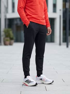 Style with tapered black joggers and a fitted quarter-zip pullover in a matching solar red hue for a sleek, post-workout athleisure ensemble.