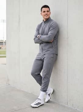 A tapered gray performance tracksuit with crew-length white athletic socks to maintain a clean, professional training look.