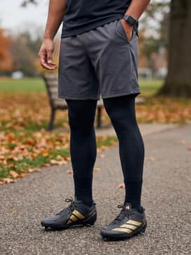 Adizero Electric Football Cleats – Black performance compression leggings worn under lightweight charcoal grey athletic shorts and a fitted long-sleeve tech tee for intense training sessions.