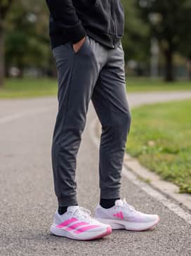 Dark grey tapered joggers and a black zip-up hoodie for a sleek, sporty look that transitions from class to practice.