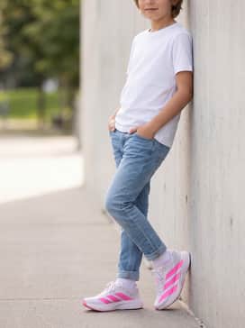 Slim-fit light-wash jeans and a crisp white t-shirt to let the vibrant sneaker accents serve as the main pop of color.