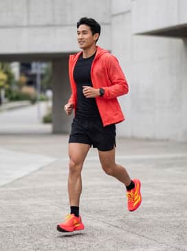 Adizero Evo Sl – Black 5-inch inseam moisture-wicking running shorts paired with a matching black compression short-sleeve tee and a lightweight red packable windbreaker.