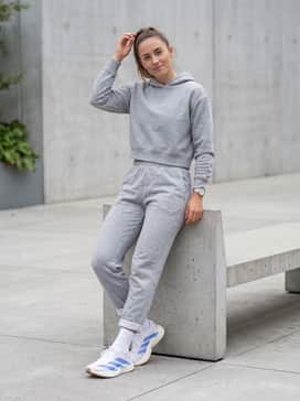 Adizero Evo Sl Shoes – Heather grey joggers and a matching cropped hoodie with white crew socks pulled over the hem for a cozy, trendy post-gym aesthetic.