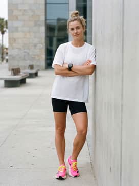 Adizero Evo Sl Shoes – A summer workout ensemble consisting of black bike shorts, a breathable white mesh oversized jersey, and no-show performance socks.