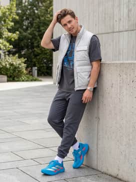 Streetwear Edge: Combine with light-wash tapered denim, a graphic tee featuring blue tones, and a metallic silver puffer vest for a bold, urban look.