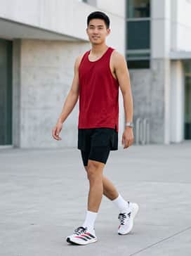 Performance Look: A crimson moisture-wicking racing singlet paired with black 5-inch split shorts and white compression socks for a race-ready aesthetic.