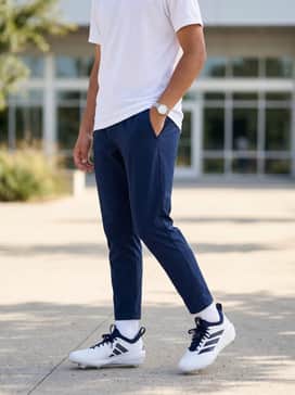 Adizero Impact 20 Baseball Cleats – High-performance practice gear including navy blue tapered track pants, a white breathable mesh training tee, and a matching adidas baseball cap.