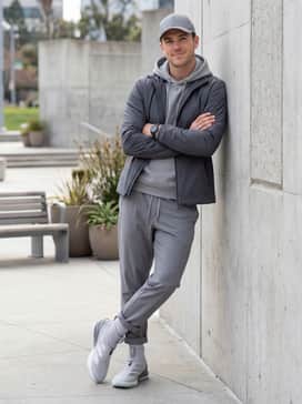 Adizero Impact 20 Baseball Turf Shoes – Casual Sportswear: Slim-fit navy blue joggers with a side stripe, a light grey heavyweight cotton hoodie, and a sleek black baseball cap for a coordinated post-practice look.