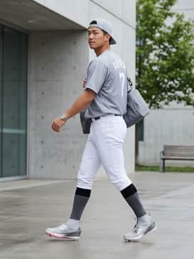 Adizero Impact 20 Cleats – Full baseball uniform featuring a moisture-wicking team jersey and tapered white baseball pants tucked to show the high-top profile.