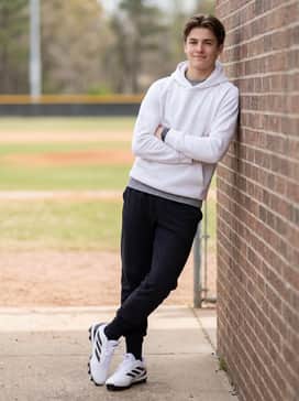 Pre-game warmup attire with black tapered athletic joggers, a white tech fleece hoodie, and black high-performance crew socks.