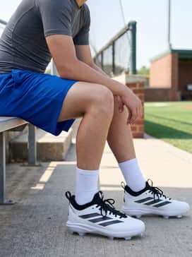 Adizero Impact 20 Tpu Baseball Cleats Kids – Vibrant team-colored mesh athletic shorts worn with a lightweight compression shirt and crew-length white performance socks for summer training drills.