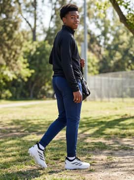 Adizero Impact 20 Tpu Baseball Cleats Kids – A professional pre-game travel ensemble consisting of a black quarter-zip athletic pullover and tapered navy blue track pants to maintain a sporty aesthetic off the field.