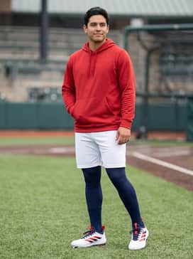 Adizero Impact Tpu 20 Usa Cleats – Pre-game training attire consisting of navy blue compression leggings, white athletic shorts, and a lightweight moisture-wicking red hoodie.