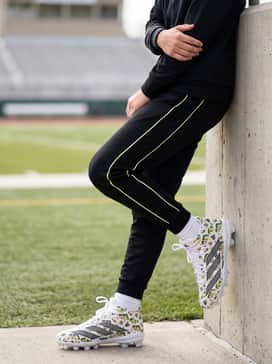 Sleek Warm-Up Fit: Wear with a tapered black tracksuit featuring subtle neon piping and a matching white headband for a coordinated pre-game appearance.