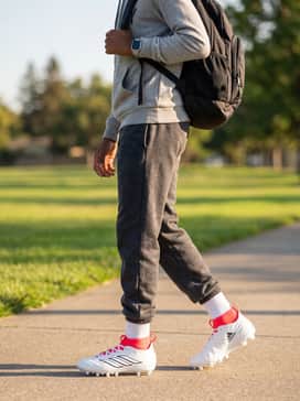Adizero Impact2 Ii Kids Patrick Mahomes Cleats – A comfortable travel ensemble for game day, including fleece joggers, a graphic hoodie, and a sports-ready backpack.