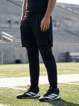 A high-intensity practice outfit consisting of a charcoal moisture-wicking compression shirt, black athletic shorts with side vents, and matching wristbands.