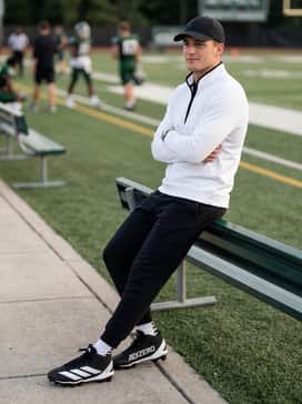 Adizero Impact2 Molded Rubber Football Cleats – A sideline warm-up ensemble including tapered black fleece joggers, a lightweight quarter-zip tech pullover in white, and a brand-matched athletic cap.
