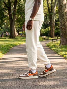 Off-white sweatpants and a matching quarters-zip fleece top for a cohesive, monochromatic lounge look that allows the brown and orange tones of the sneaker to stand out.