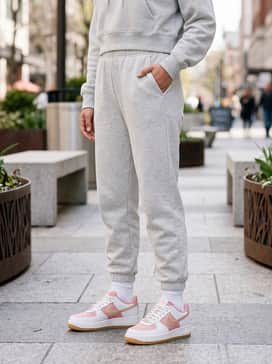 Light grey joggers combined with a matching cropped hoodie and white crew socks to lean into a cozy, athletic-leisure vibe.