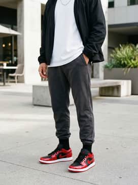 Dark charcoal tapered joggers and a clean, oversized white t-shirt layered under a black windbreaker to let the shoes be the primary focal point.