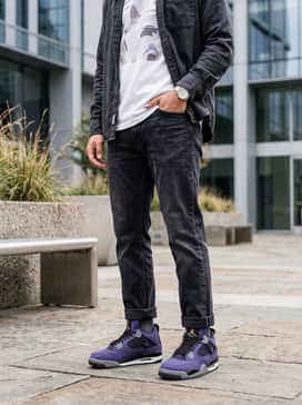 Combine them with washed black straight-leg jeans, a clean white graphic t-shirt featuring subtle purple details, and an unbuttoned charcoal flannel shirt.