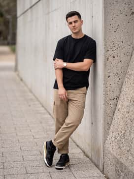 Opt for relaxed-fit khaki cargo pants with a tucked-in black graphic t-shirt and a gold-tone watch to lean into an urban explorer aesthetic.