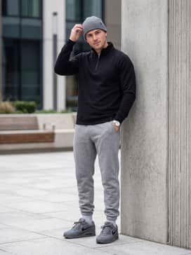 Air Max 90 Premium – A modern athleisure outfit consisting of grey fleece sweatpants, a black performance quarter-zip pullover, and a matching grey beanie for a tonal finish.