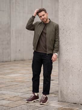Combine with black utility cargo pants and a structured olive green bomber jacket for a rugged, tactical streetwear vibe.