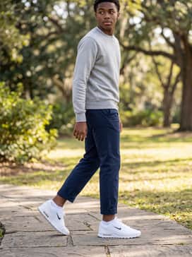 Air Max Bia – Navy blue cuffed chinos worn with a heather grey sweatshirt and no-show socks to achieve a polished yet relaxed preppy vibe that highlights the sneaker's clean lines.